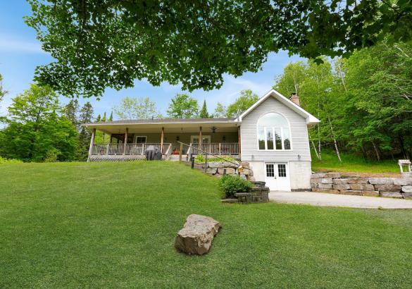 House with Covered porch, with grass leading up to it