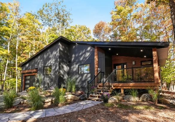dark grey home with covered front porch and stone walkway